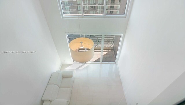 60 SW 13th St Unit 3820, Miami, FL 33130 - stairs with a towering ceiling, tile patterned flooring, and baseboards
