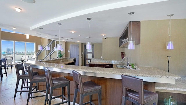 60 SW 13th St Unit 3820, Miami, FL 33130 - kitchen featuring a sink, light tile patterned floors, a spacious island, and decorative light fixtures