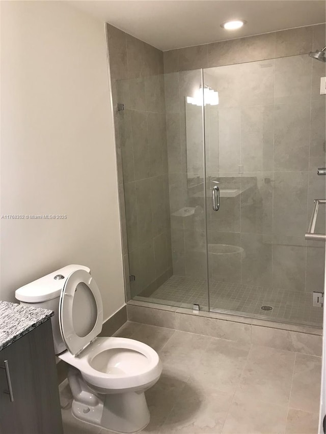 5350 NW 84th Ave Unit 1814, Doral, FL 33166 - bathroom featuring vanity, a shower stall, toilet, and tile patterned floors