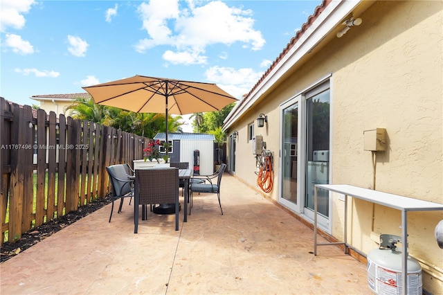 5717 NW 102nd Pl, Doral, FL 33178 - view of patio with an outbuilding, fence, and outdoor dining space