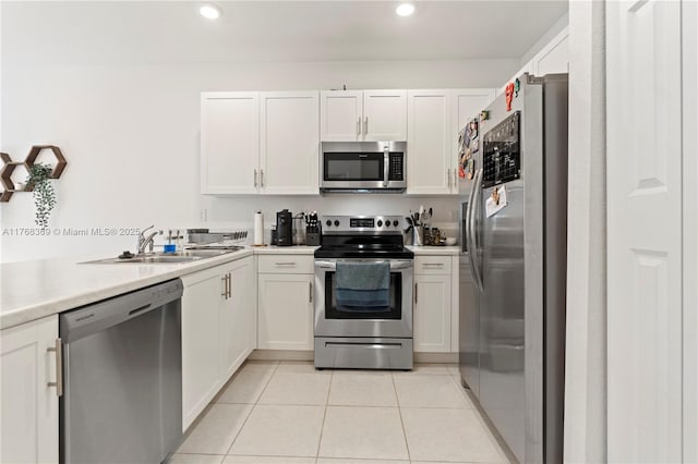 kitchen with white cabinetry, light tile patterned floors, appliances with stainless steel finishes, and a sink