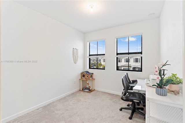 carpeted office space featuring baseboards
