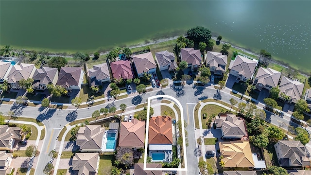 bird's eye view with a residential view and a water view