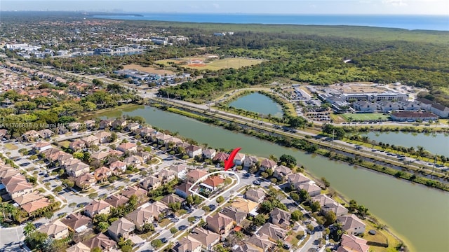 bird's eye view with a residential view and a water view