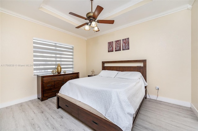 bedroom with ceiling fan, baseboards, light wood-style floors, and ornamental molding