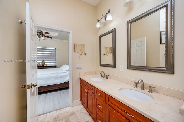 ensuite bathroom featuring double vanity, tile patterned floors, ensuite bath, and a sink