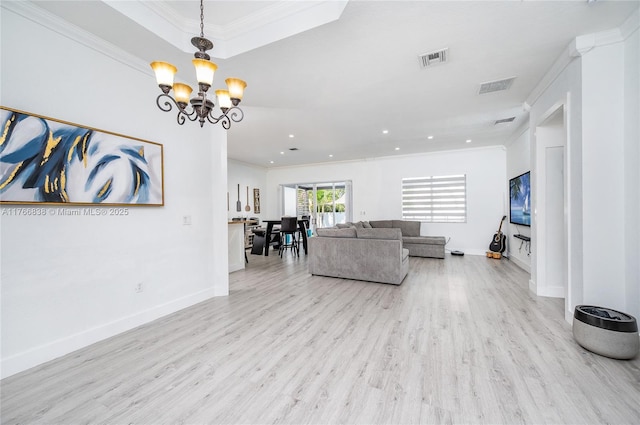 living area with visible vents, wood finished floors, and crown molding