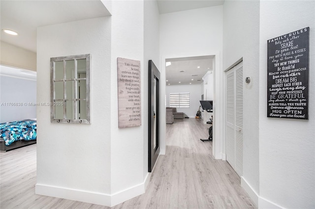 hall with recessed lighting, baseboards, and wood finished floors