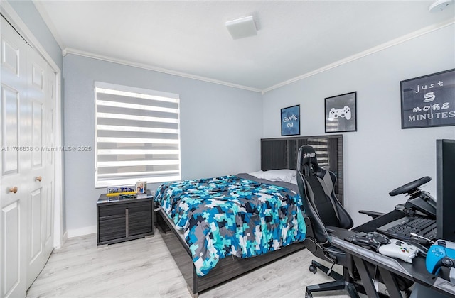 bedroom with wood finished floors and ornamental molding