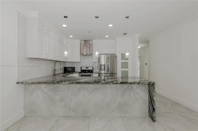 kitchen featuring dark stone countertops, wall chimney exhaust hood, crown molding, and stainless steel appliances
