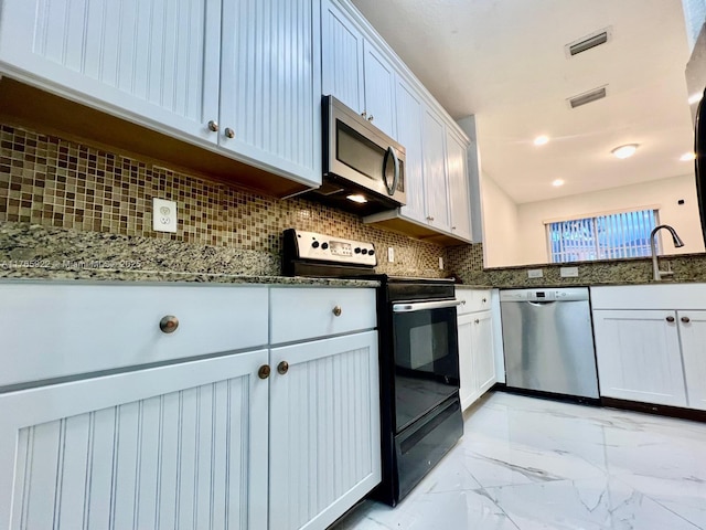 8962 SW 18th St Unit 1109, Miramar, FL 33025 - kitchen featuring dark stone countertops, a sink, backsplash, appliances with stainless steel finishes, and marble finish floor