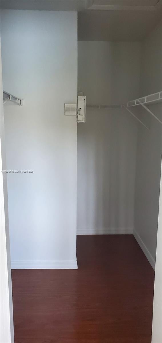 walk in closet with wood finished floors and visible vents