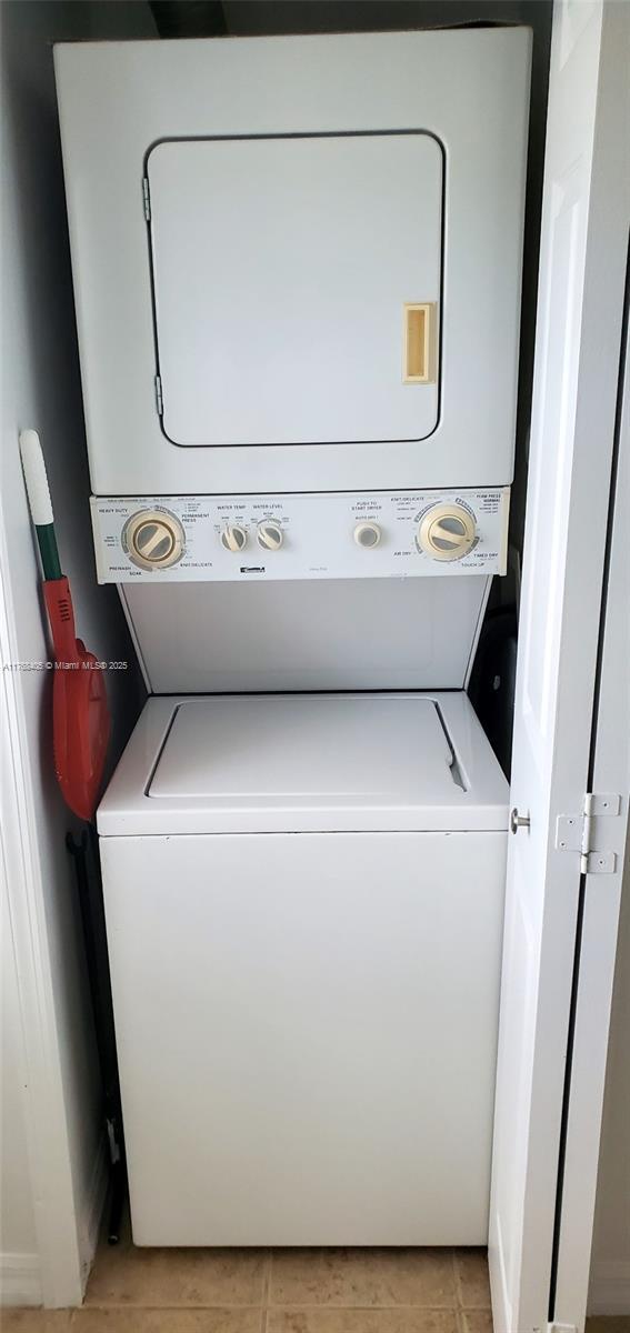 washroom with laundry area and stacked washer / dryer