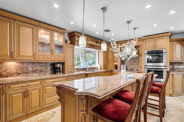 6400 Marlin Dr, Coral Gables, FL 33158 - kitchen with stainless steel double oven, a sink, a center island, light stone countertops, and backsplash