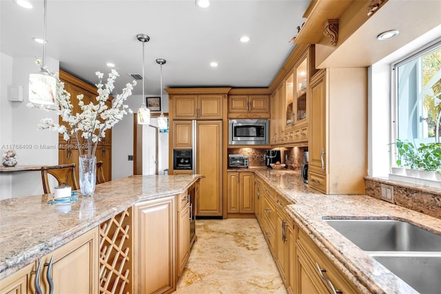 6400 Marlin Dr, Coral Gables, FL 33158 - kitchen featuring built in appliances, light stone counters, pendant lighting, glass insert cabinets, and recessed lighting