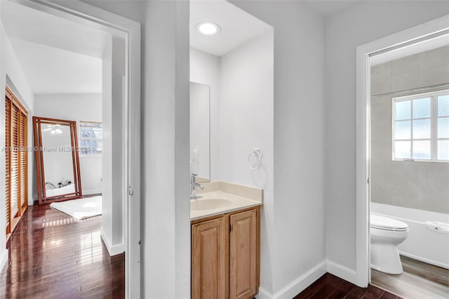6400 Marlin Dr, Coral Gables, FL 33158 - full bathroom featuring wood finished floors, baseboards, toilet, vanity, and a bathtub