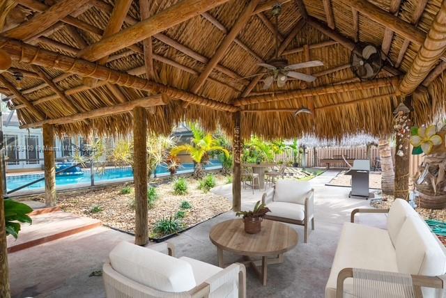 6400 Marlin Dr, Coral Gables, FL 33158 - view of patio / terrace featuring a gazebo, a ceiling fan, outdoor lounge area, an outdoor pool, and outdoor dining area