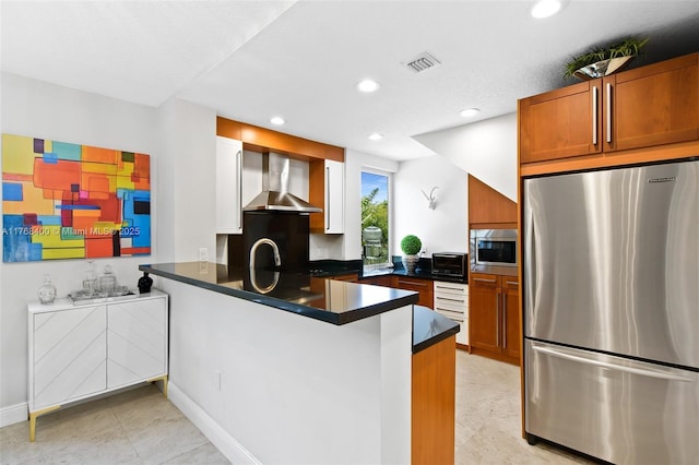 306 NE 8th Ave Unit 306, Fort Lauderdale, FL 33301 - kitchen with appliances with stainless steel finishes, wall chimney exhaust hood, a peninsula, dark countertops, and recessed lighting