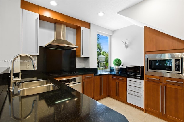 306 NE 8th Ave Unit 306, Fort Lauderdale, FL 33301 - kitchen with wall chimney exhaust hood, stainless steel appliances, a sink, dark stone countertops, and recessed lighting