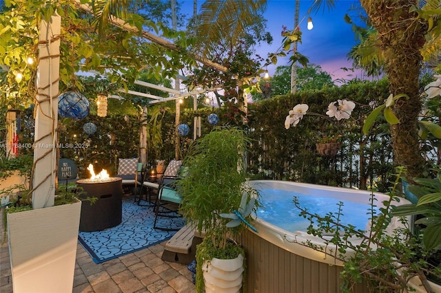 306 NE 8th Ave Unit 306, Fort Lauderdale, FL 33301 - pool at dusk featuring a hot tub, a patio, and a fire pit