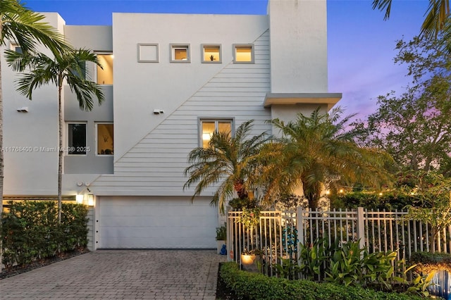 306 NE 8th Ave Unit 306, Fort Lauderdale, FL 33301 - view of front facade with an attached garage, driveway, stucco siding, and a chimney