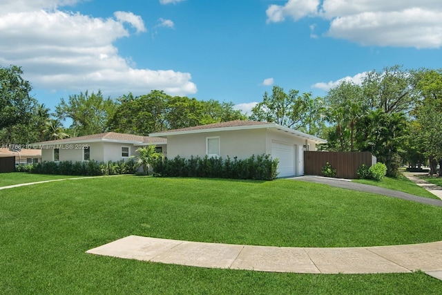 7640 SW 165th Ter, Palmetto Bay, FL 33157 - view of front of home featuring a front yard, driveway, stucco siding, and an attached garage