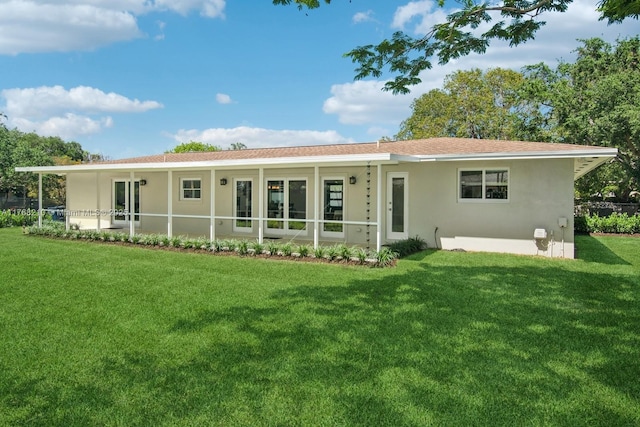 7640 SW 165th Ter, Palmetto Bay, FL 33157 - rear view of property with stucco siding and a lawn