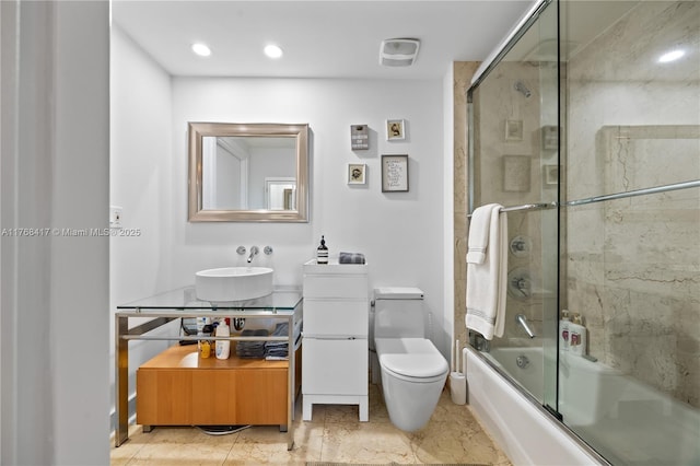 bathroom featuring toilet, recessed lighting, vanity, and bath / shower combo with glass door