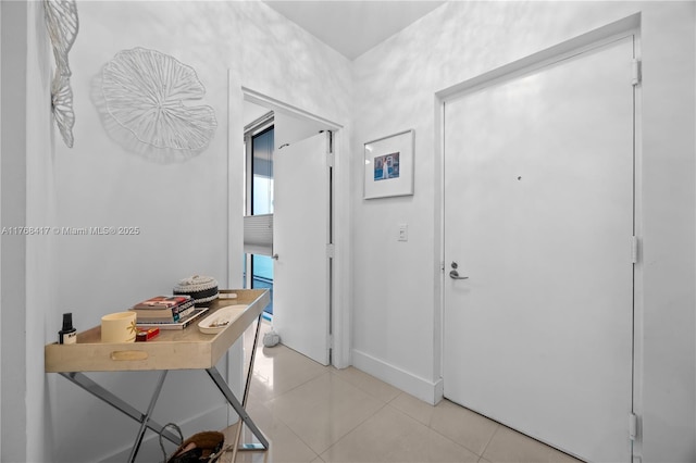 entryway featuring light tile patterned floors and baseboards