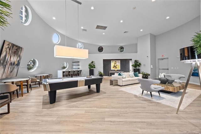 game room featuring light wood-style flooring, high vaulted ceiling, visible vents, and recessed lighting