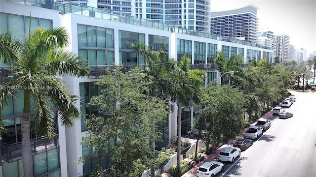 view of property with a city view and uncovered parking