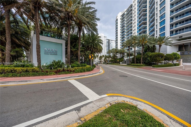 view of road with curbs, traffic signs, and sidewalks