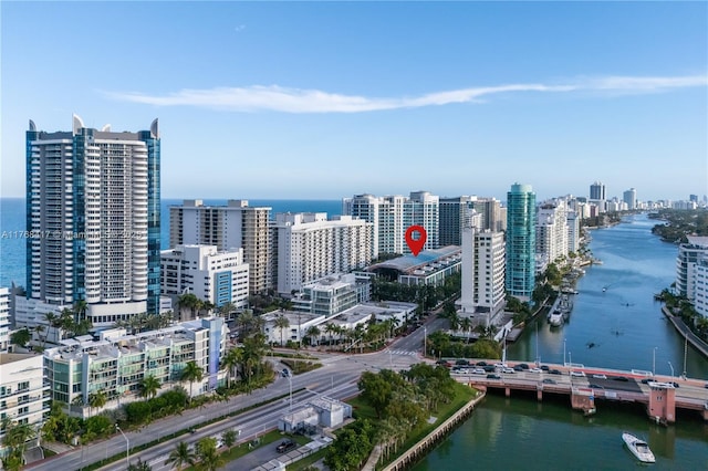 birds eye view of property featuring a water view and a view of city
