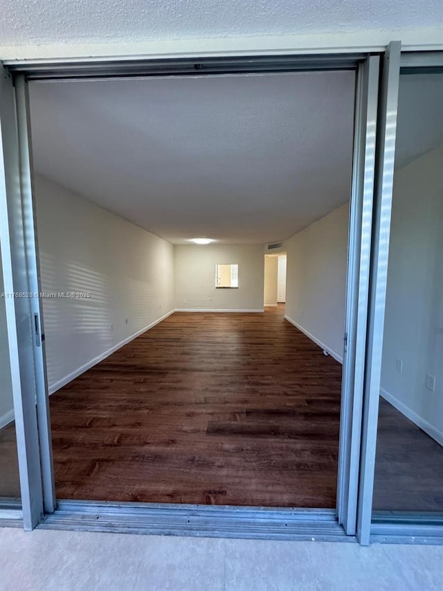 1201 NE 191st St Unit G313, Miami, FL 33179 - empty room featuring baseboards and wood finished floors
