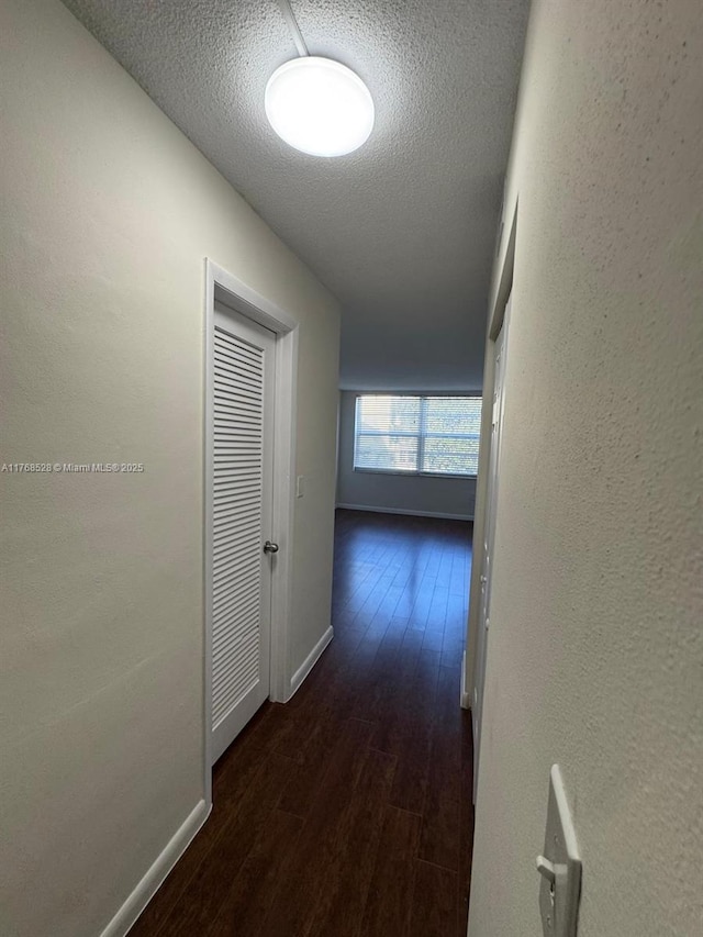 1201 NE 191st St Unit G313, Miami, FL 33179 - hallway with wood finished floors, baseboards, a textured wall, and a textured ceiling