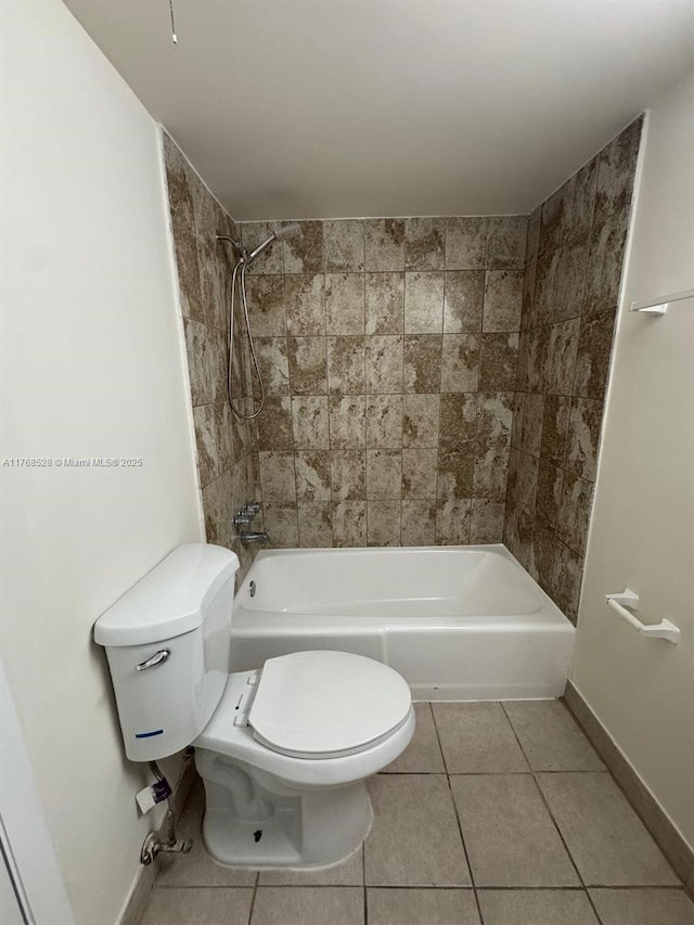 1201 NE 191st St Unit G313, Miami, FL 33179 - full bath with tile patterned flooring, toilet, baseboards, and shower / washtub combination
