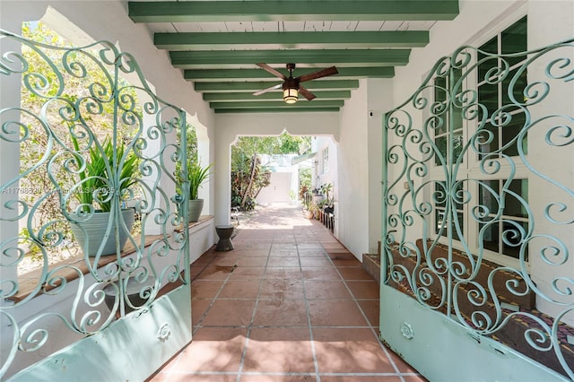 view of patio / terrace with ceiling fan and a gate