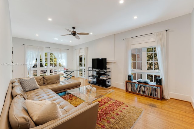 living room with a ceiling fan, recessed lighting, wood finished floors, and baseboards