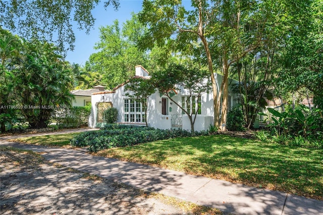 view of property exterior featuring stucco siding and a yard