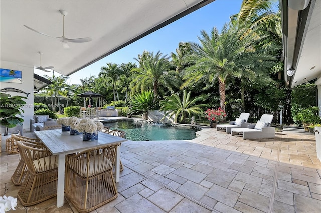 outdoor pool featuring a patio, ceiling fan, and outdoor dining area