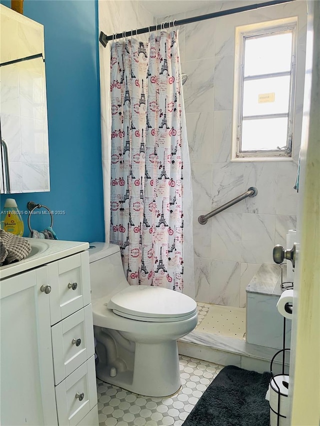 full bath featuring vanity, toilet, and a stall shower