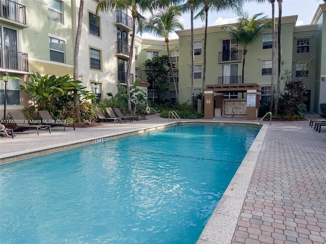 community pool with a patio area