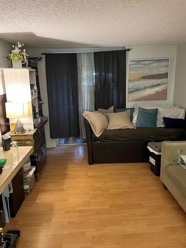 8101 N Sunrise Lakes Dr Unit 105, Sunrise, FL 33322 - living area featuring a textured ceiling and light wood-style flooring