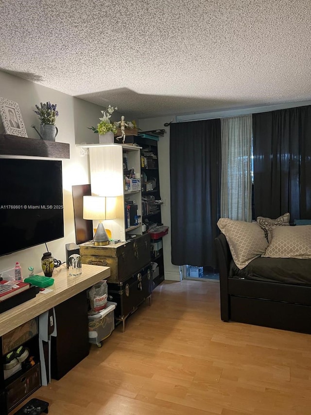 8101 N Sunrise Lakes Dr Unit 105, Sunrise, FL 33322 - living area featuring wood finished floors and a textured ceiling