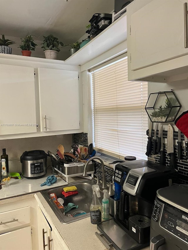 8101 N Sunrise Lakes Dr Unit 105, Sunrise, FL 33322 - kitchen featuring white cabinetry, a sink, and light countertops