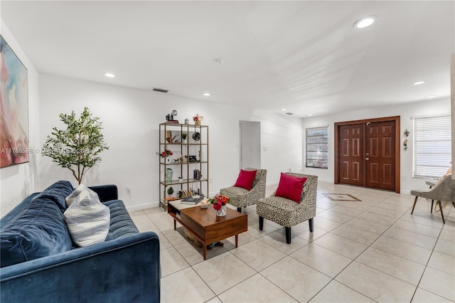 living room with light tile patterned flooring, recessed lighting, visible vents, and baseboards