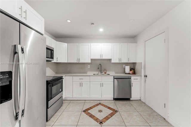 kitchen with electric range, a sink, light countertops, stainless steel dishwasher, and fridge with ice dispenser