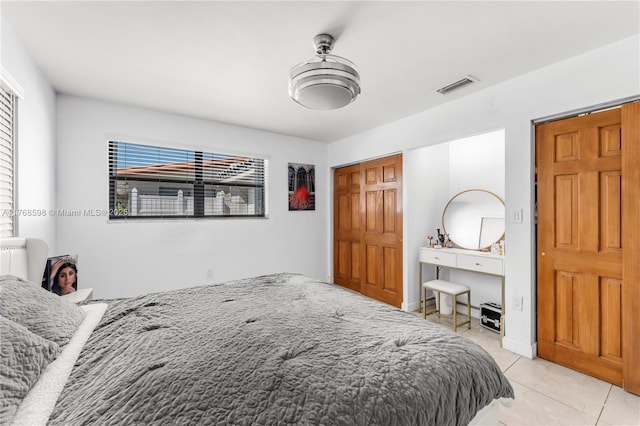 bedroom with light tile patterned floors and visible vents