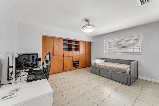 office space featuring light tile patterned floors, visible vents, and baseboards