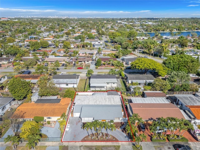 drone / aerial view with a residential view and a water view